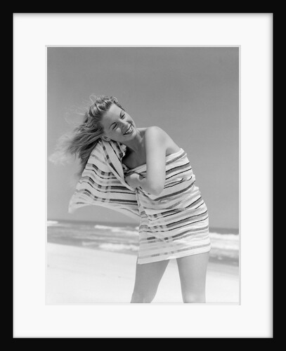 1950s 1960s Woman Wrapped In Stripped Towel Drying Hair On Beach Smiling by Anonymous