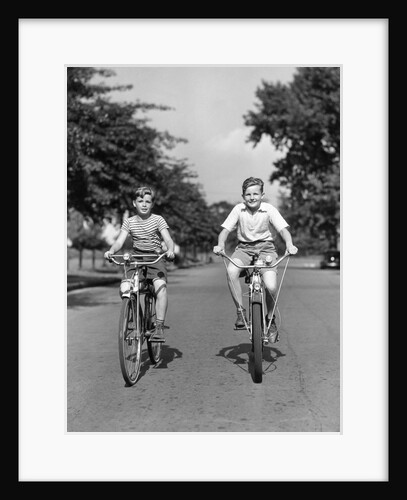 1930s 1940s Two Boys Riding Bikes On Tree Lined Street by Anonymous