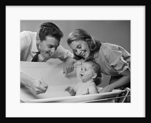 1950s Parents Leaning Over Tub Bathing Happy Baby by Anonymous