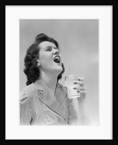 1940s Woman Gargling Medicine Holding A Glass Indoor by Anonymous