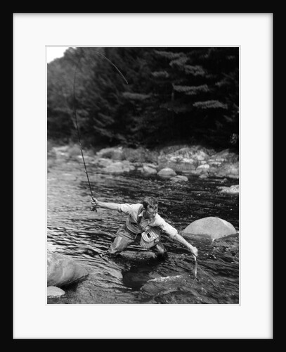 1920s Man In Stream Wearing Waders With Fish On Line Trying To Catch It In Net by Anonymous