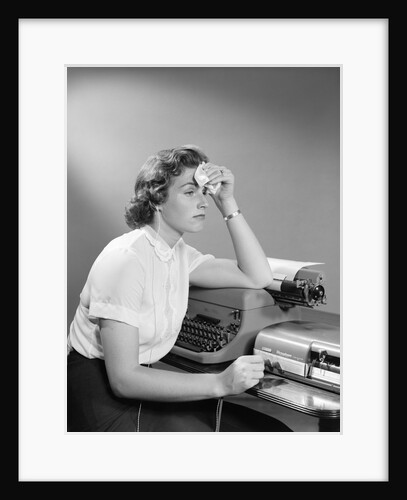 1950s Ailing Secretary Sitting At Desk With Typewriter And Dictation Machine Holding Handkerchief To Forehead by Anonymous