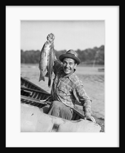 1940s 1950s Happy Man Fishing From A Rowboat Holding Up Fish Just Caught With Pride by Anonymous