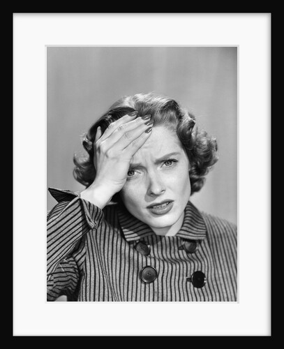 1950s Stressed Woman In Striped Dress Hold Forehead With Hand by Anonymous