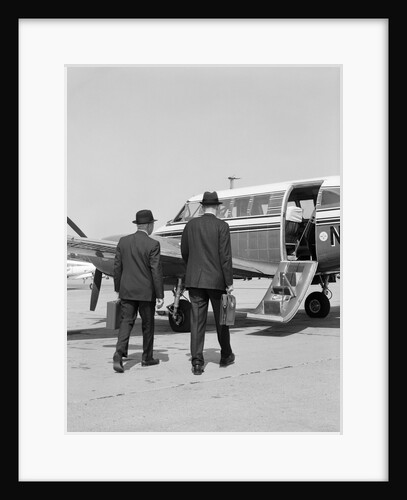 1960s Two Businessmen Walking Together To A Small Private Propeller Airplane Carrying Briefcase by Anonymous