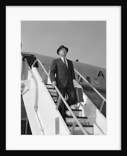1960s Businessman Deplaning From Airplane Wearing Hat And Carrying Overcoat And Briefcase by Anonymous