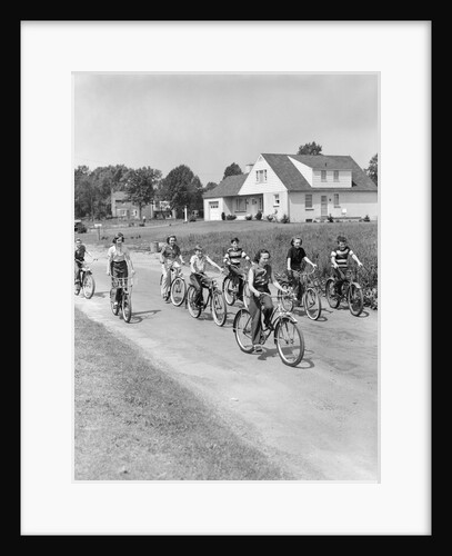 1950s 8 Kids Boys and Girls Ride Bicycles On Country Rural Road Lane Fun House In Background by Anonymous