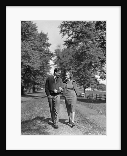1930s 1940s Young Teen Couple Boy Girl Strolling Down Autumn Country Lane Arm In Arm by Anonymous