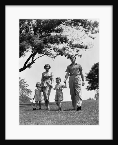 1950s Happy Family Mother Father Daughter Son Walking In Park by Anonymous