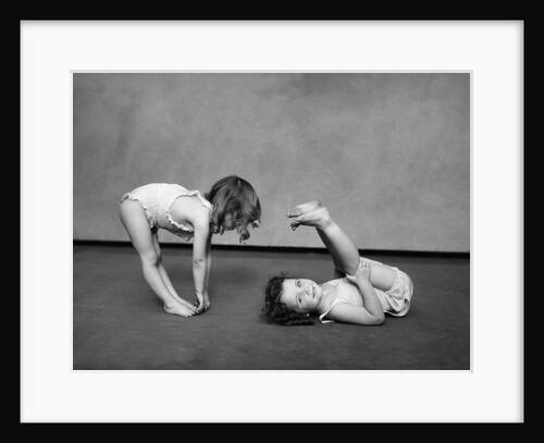1930s Two Girls Wearing Underclothes Playing At Exercising by Anonymous