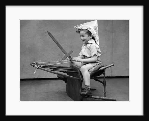 1930s Boy Playing Wooden Sword Paper Hat Riding Chair Like A Horse by Anonymous