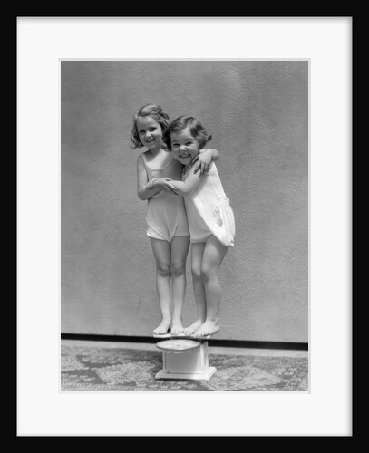 1930s Two Little Girls Standing On Scale Arm In Arm Smiling by Anonymous