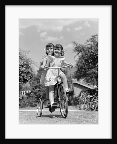 1940s Twin Girls Riding Outside On Tricycle by Anonymous