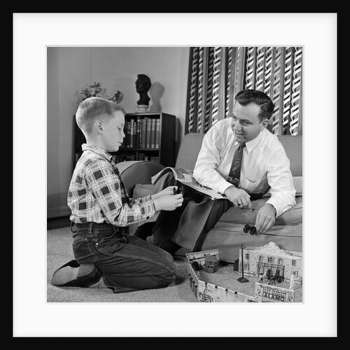 1950s Father And Son Playing With Cowboy Toy Game In Living Room Indoor by Anonymous