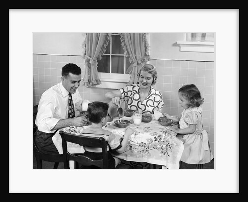 1950s Family Sitting At Kitchen Table Having Breakfast by Anonymous
