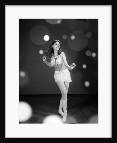 1960s Woman Dancing In White Fringed Halter Top Mini-Dress Skirt And Go-Go Boots by Anonymous