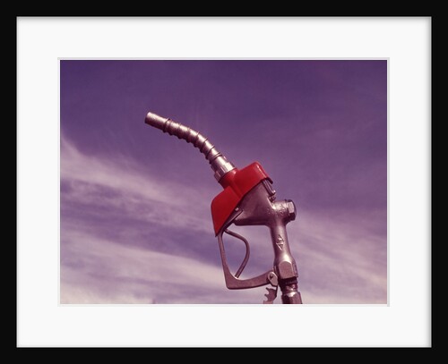 1960s Nozzle Handle Of Gasoline Pump With Blue Sky Background by Anonymous