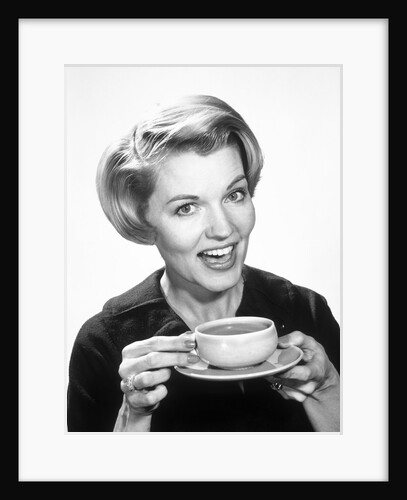 1960s Woman Drinking Coffee Holding Cup And Saucer by Anonymous
