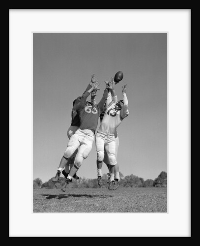 1960s Three Football Players Reaching To Catch Ball by Anonymous