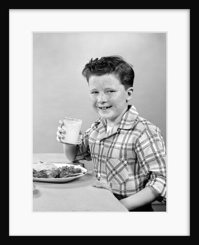 1930s 1940s Freckle-Faced Boy Sitting Dinner Table Holding Glass Milk by Anonymous