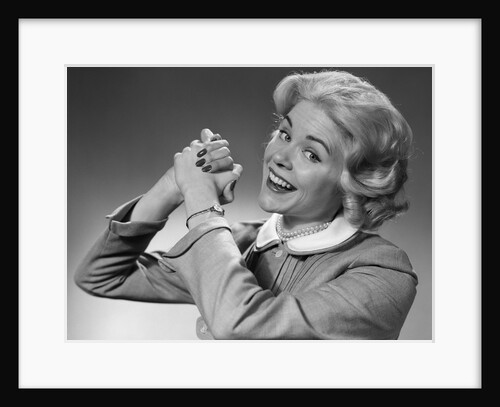 1950s 1960s Woman Making Winning Symbolic Hand Gesture With Raised Clasped Hands by Anonymous