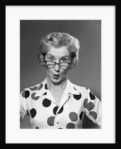1950s 1960s Portrait Woman Polka Dot Dress Looking Over Eyeglasses by Anonymous