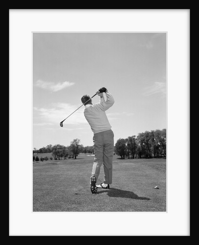 1950s 1960s Rear View Man Swinging Golf Club by Anonymous