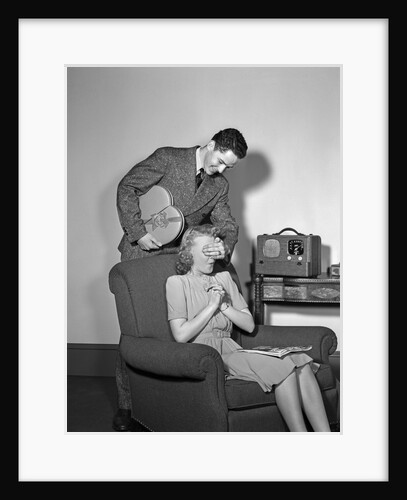 1940s Teen Couple Boy With Hand Over Girl Eyes Surprising Her With Box Of Valentines Day Candy by Anonymous