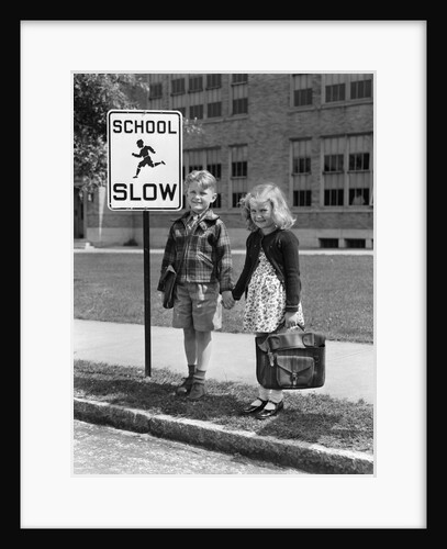 1930s 1940s Boy Girl Holding Hands Next To School Slow Sign by Anonymous