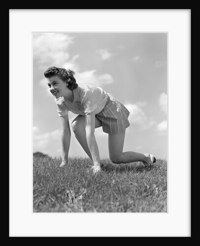 1940s Young Teen Woman Kneeling In Grass In Track Race Ready Starting Position by Anonymous