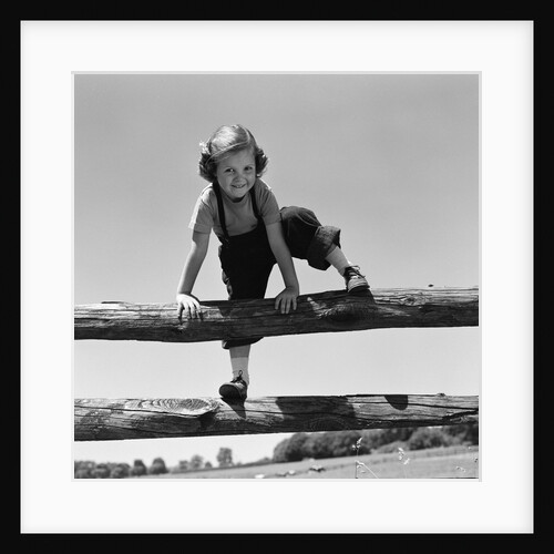 1940s 1950s Girl Climbing Over Wooden Fence by Anonymous