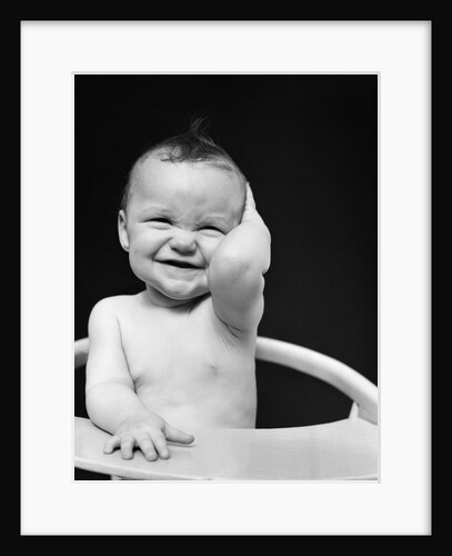 1940s Portrait Of Baby Holding Hand To Side Of Head by Anonymous