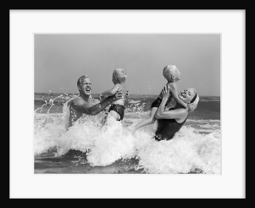 1970s 1960s Family Father Mother Holding Up A Twin Sons In The Ocean Surf by Anonymous