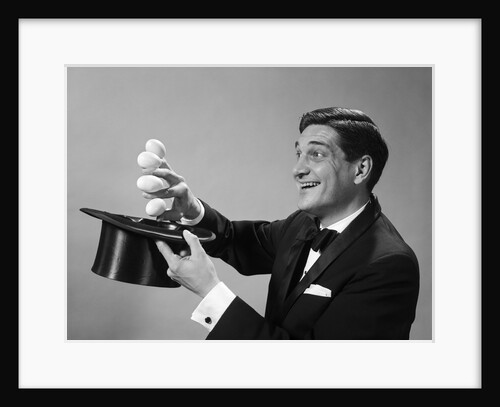 1960s Profile Magician Man Pulling 4 Eggs Out Of Hat Holding Them Between Fingers by Anonymous