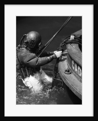 1930s Side View Of Diver In Pressure Suit Descending Into Water From Side Of Boat by Anonymous
