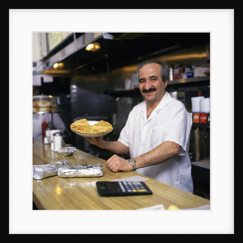 Portrait Man Working Behind Counter In Diner Holding Pie by Anonymous