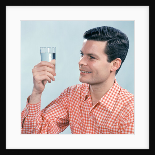 1960s Profile Man Wearing Red Checkered Shirt Holding Glass Of Water by Anonymous