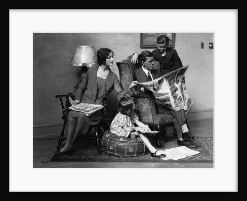 1920s Family of Four Mother Father Son Daughter in Living Room Reading Newspaper Together by Anonymous