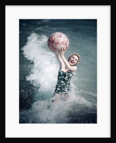 1950s Woman Jumping In Surf Holding Up Beach Ball by Anonymous
