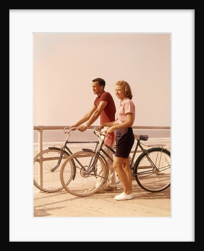 1950s 1960s Teen Couple Standing By Bikes On Beach Boardwalk by Anonymous