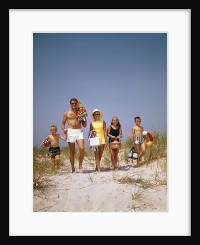 1960s Family Walking Together To The Beach Over Sand Dunes Carry Picnic And Beach Gear by Anonymous