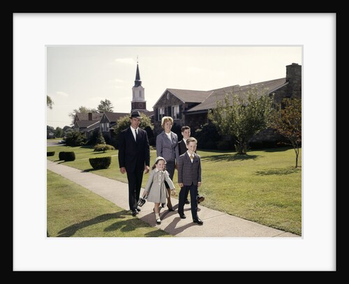 1960s Family Of 5 Walking On Suburban Sidewalk Church Steeple In Background by Anonymous