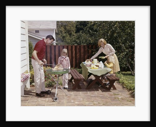 1960s Family Father Mother Two Daughters Barbeque In Backyard On Brick Patio by Anonymous