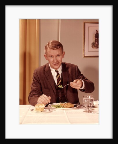1960s Man Eating Dinner At Table With Fork Full Of Peas by Anonymous