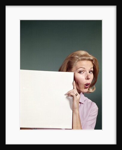 1960s Portrait Of Surprised Woman Peeking Around Sign Board by Anonymous