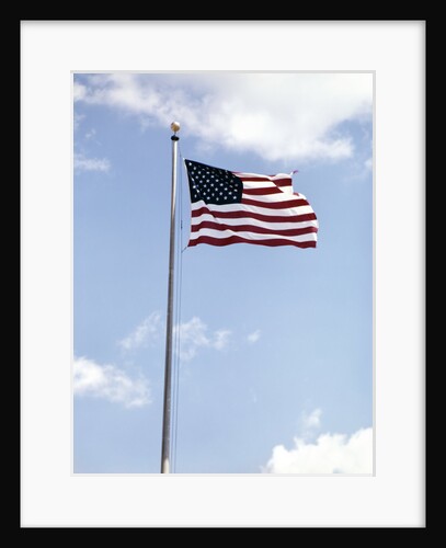 1960s American Flag On Pole Flying Against Blue Sky With Clouds by Anonymous