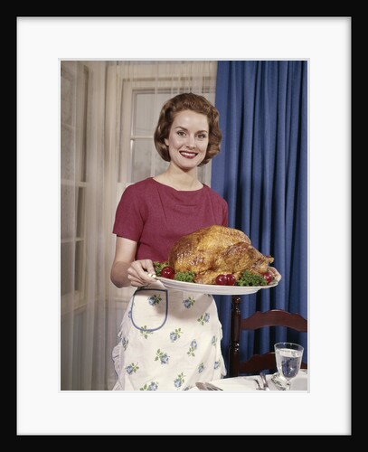 1960s Woman Serving Thanksgiving Turkey Dinner by Anonymous
