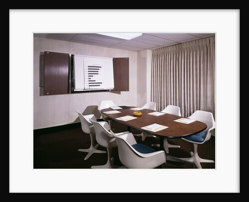 1960s Office Conference Room With Table Chairs Writing Pads Ashtray And Wall Chart by Anonymous