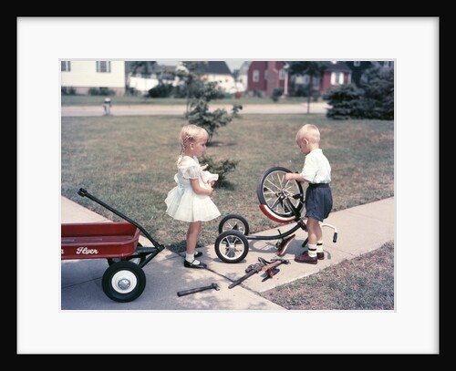 1950s Little Girl Sister Holding Doll Watching Little Boy Brother Repair Tricycle by Anonymous