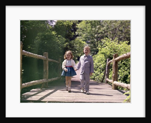 1960s Little Boy And Girl Holding Hands And Walking Across Wooden Footbridge by Anonymous